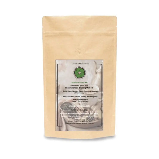 A stand-up kraft paper pouch of Sassy Charm Chai with a central white and green label, photographed on a clean white background. 